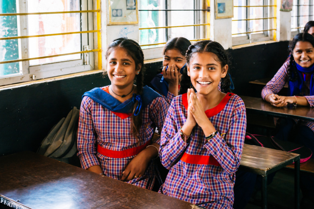 A photograph, courtesy of Girl Rising, of a group of excited young female students in a classroom in India.