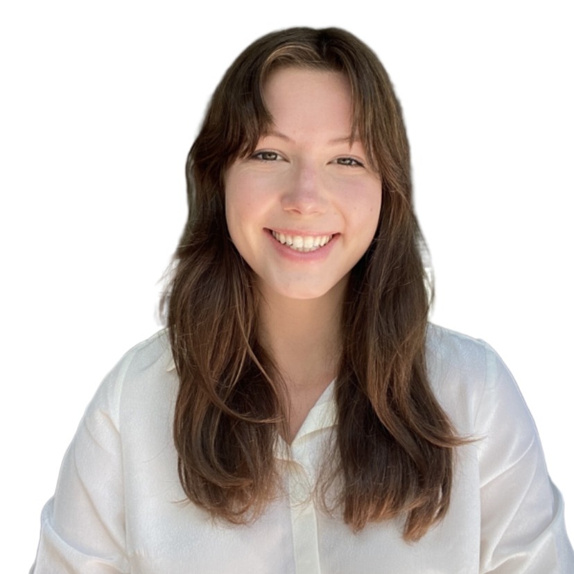 Connie Moore's headshot. A person with long hair and side bangs, wearing a collared shirt, smiles at the camera.