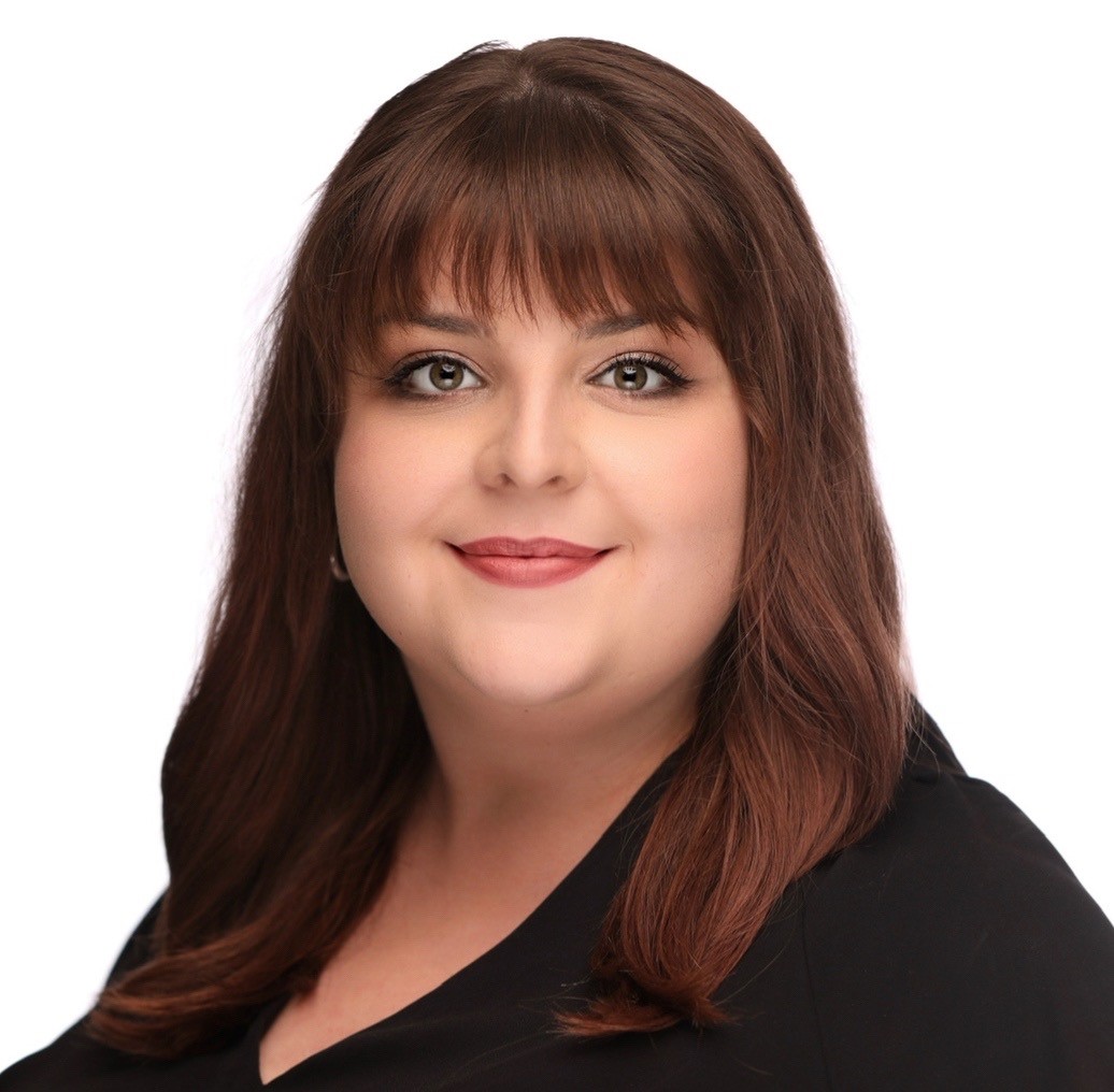 Sofia Espino Yaeger's headshot. A person with long, dark hair and bangs looks at the camera.