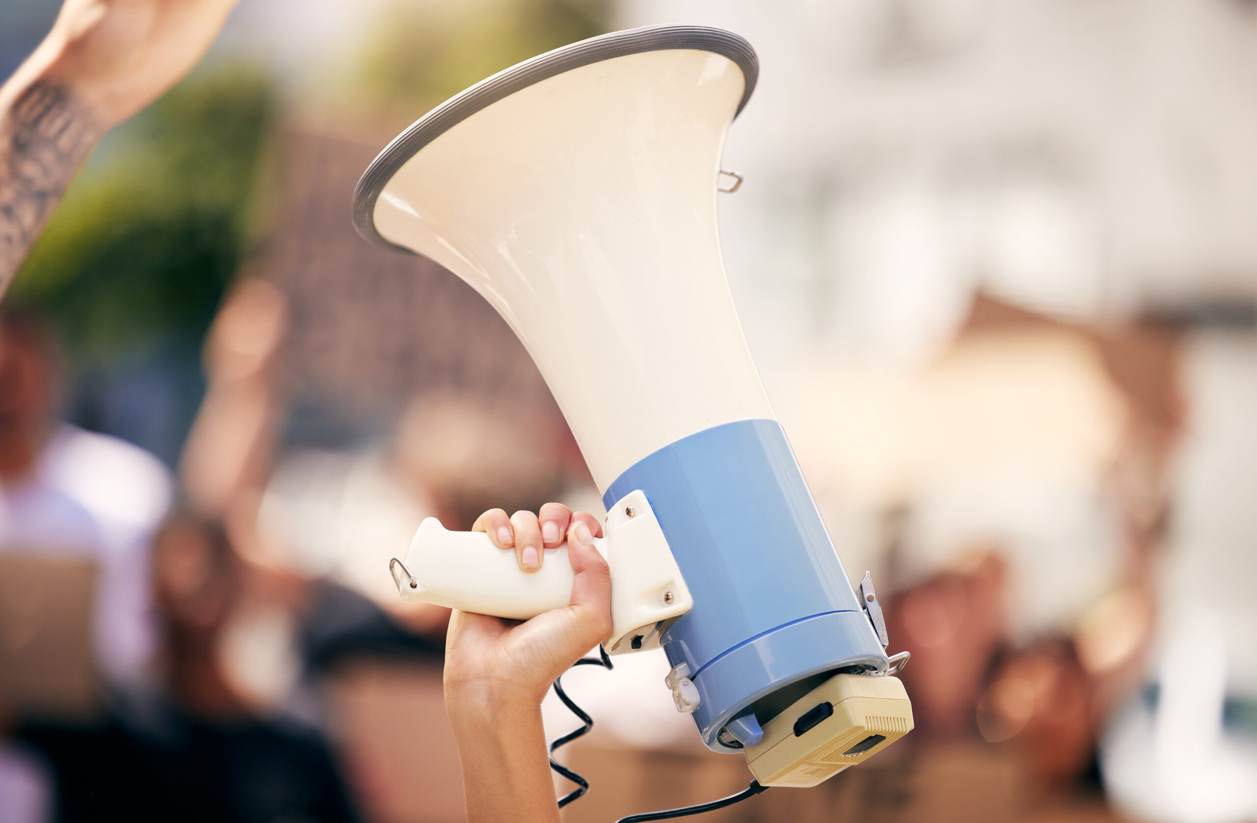 A photograph of a megaphone held in the air, representing the next gen making their voices heard.