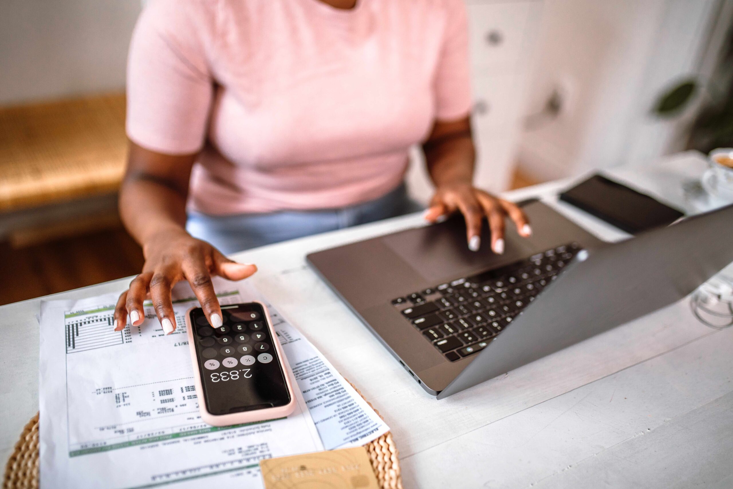 A cropped photograph of a person handling their personal finances. It illustrates the lack of AI integration in the current state of worker financial security.