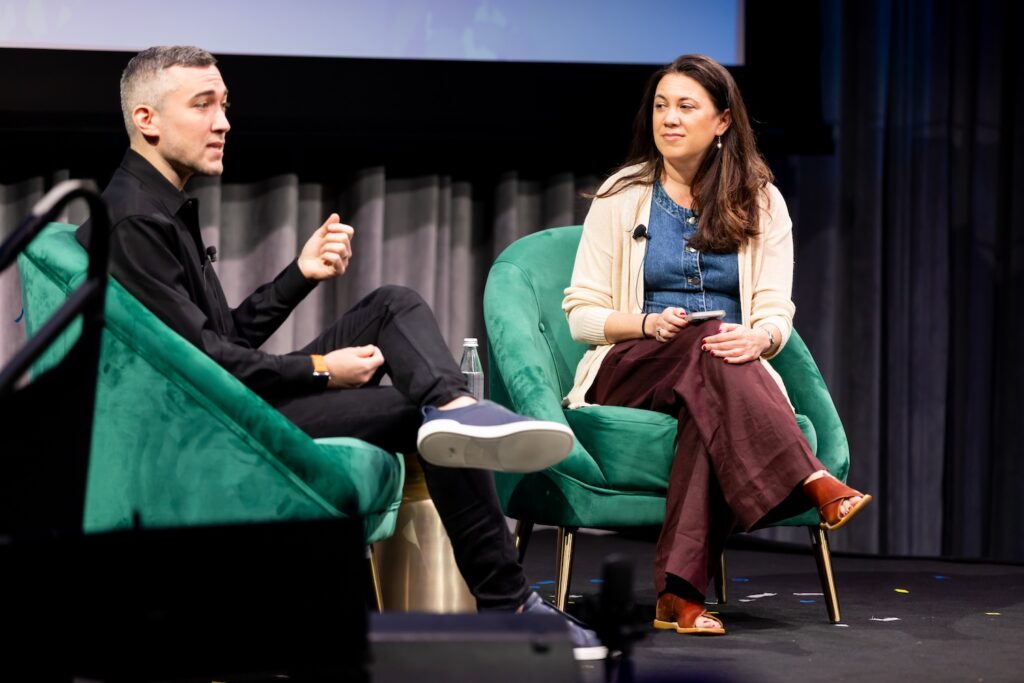Yoel Roth and Lisa Bonos on stage at Shared Futures.