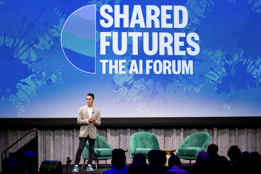 Minh Do on stage at Shared Futures.