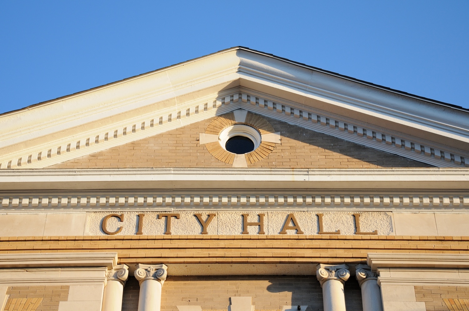 A building reading "City Hall," representing state and local government.