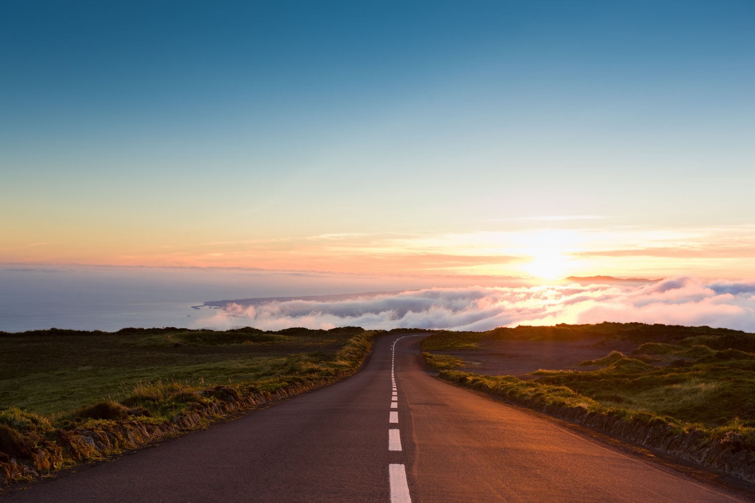 A photograph of a sunrise over a winding road, representing the launch of the Cyber Civil Defense Emerging Leaders pilot program.
