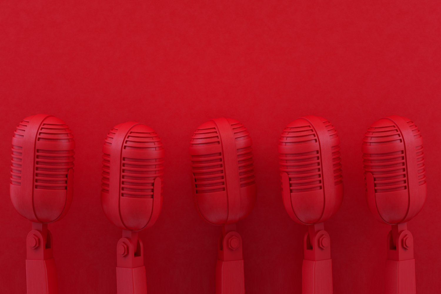 Monochrome red microphones against a red background