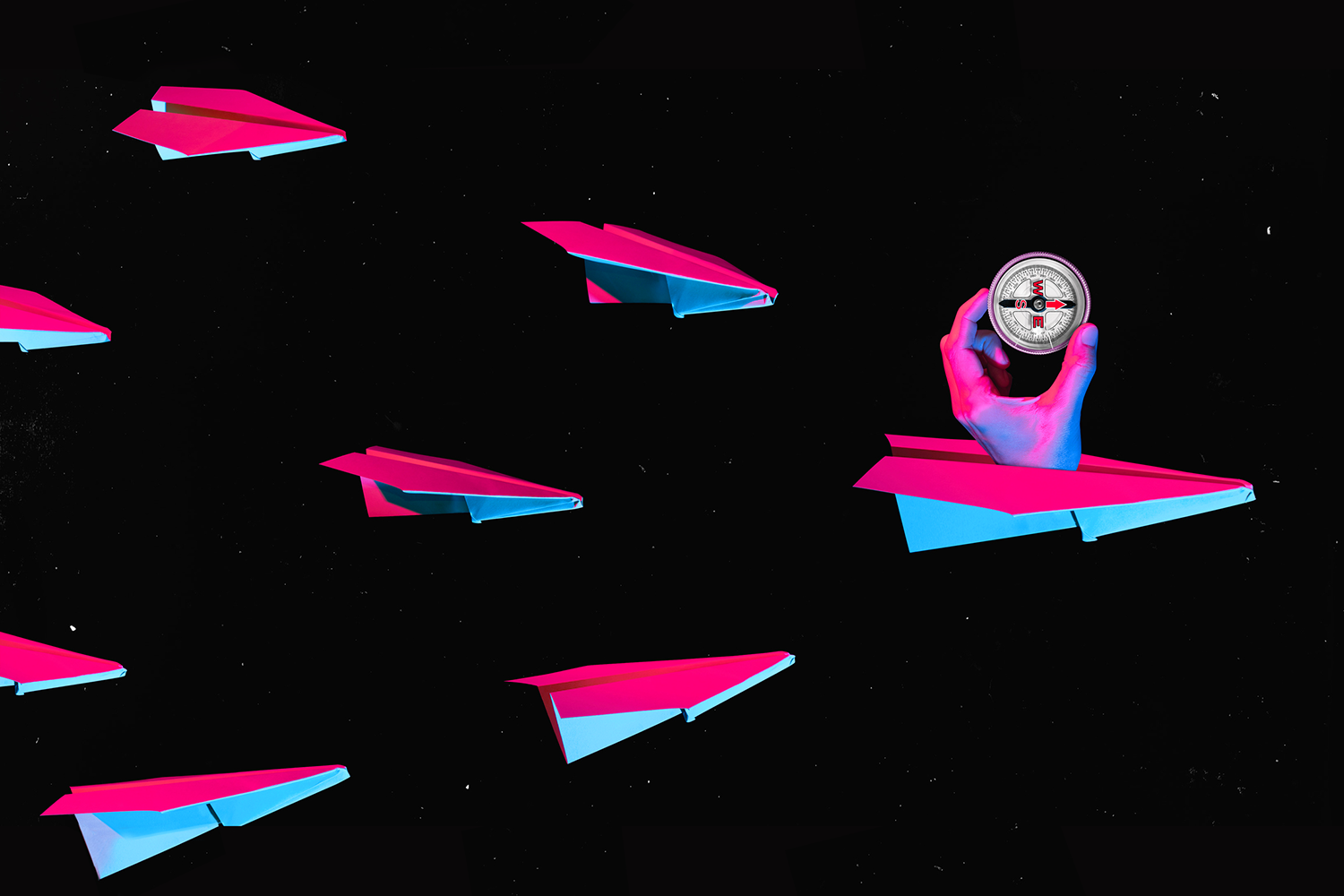 A colorful collage of paper airplanes navigating outers space with a hand holding a compass leading the way